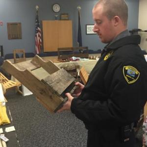 Correctional Officer Terry Marks looks over a potential Christmas gift at Two Bridges Regional Jail’s craft fair Nov. 28. SUSAN JOHNS/Wiscasset Newspaper