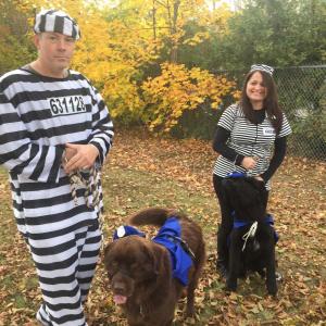 A pair of dogs in badges serve as wardens for Wiscasset’s Herb Leighton and wife and fellow pretend prisoner Loretta Leighton. SUSAN JOHNS/Wiscasset Newspaper