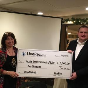 At its first meeting in Augusta on Dec. 3, VRPOMe (Vacation Rental Professionals of Maine) President Audrey L. Miller is presented with a check for $5000 by Tyler Hurst, vice president of marketing for LiveRez Software (Boise, Idaho). LiveRez owner Tracy Lotz said, “We want to support and affirm the successful and continuing efforts of this new Maine group in dealing with legislative and regulatory issues affecting vacation rentals in Maine, especially during the past three years.” There were 65 people in attendance representing over 31 Maine vacation rental businesses. Courtesy photo