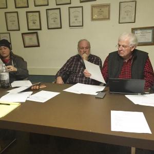 Alna Third Selectman Doug Baston, far right, looks at Wiscasset’s letter on Dec. 16. From left are Second Selectman Melissa Spinney and First Selectman David Abbott. SUSAN JOHNS/Wiscasset Newspaper