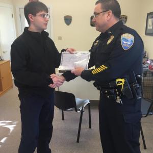 Wiscasset Reserve Patrol Officer Steven Smith, left, accepts a certificate and his uncle’s radio call number Jan. 7 from Wiscasset Police Chief Troy Cline. SUSAN JOHNS/Wiscasset Newspaper