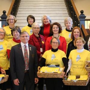 The GRR group hands postcards to legislators at State House in Augusta: Sen. Chris Johnson (front), Reps. Jay McCreight, Mattie Daughtry, Jennifer DeChant and Mick Devin (middle, from left), and Rep. Denise Tepler (back). Courtesy of Wendy Ross Eichler