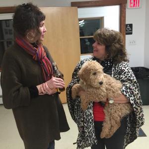 Alna Snowmobile Club members Brenda Fifield, left, and Pam Hull, holding Ruby, chat as an evening at the fire station gets under way Feb. 4. SUSAN JOHNS/Wiscasset Newspaper