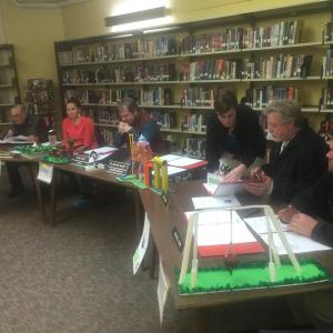 Wiscasset Superintendent of Schools Heather Wilmot speaks with Wiscasset School Committee member Glen Craig before the start of the committee’s Feb. 25 meeting. Other members, seated from left, are Vice Chairman Eugene Stover, member Chelsea Haggett, Chairman Steve Smith and member Michael Dunn. Wiscasset Elementary School students’ ideas for playground designs line the tables. SUSAN JOHNS/Wiscasset Newspaper