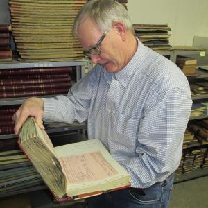 Woolwich Selectman David King Sr. enjoys reading through the old records on file in the town vault. PHIL DI VECE/Wiscasset Newspaper