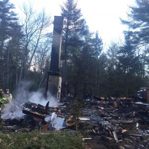 Westport Island firefighters work at an early Friday morning rekindle of the Feb. 25 fire that destroyed a North End Road home, garage and a new Subaru wagon in the garage. SUSAN JOHNS/Wiscasset Newspaper