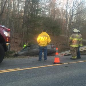 Alna firefighters stand by on Route 218 as a car is pulled from a ditch early the evening of April 30. SUSAN JOHNS/Wiscasset Newspaper