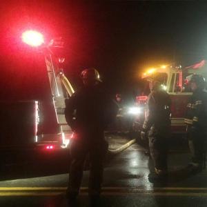 Wiscasset and Somerville firefighters load a Somerville fire truck with water on Alna’s Route 194 around 4 a.m. April 7. Somerville was helping at the scene of a Whitefield house fire. SUSAN JOHNS/Wiscasset Newspaper