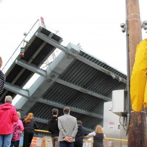 Senator Chris Johnson (in gray suit coat) and other watch as the new bridge opens on May 25. Courtesy photo