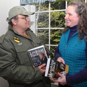 Veteran Brian Rego of Boothbay, who helped proofread Sarah Sherman McGrail’s “Looking Back, Volumes I and II,” receives the first copies of the books. Courtesy of Robert Mitchell