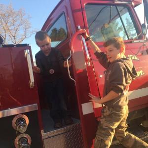 Gabriel GaNun, 5, left, and Austin Trask, 10, play tag on a fire truck during a May 18 open house at the Alna fire station. SUSAN JOHNS/Wiscasset Newspaper