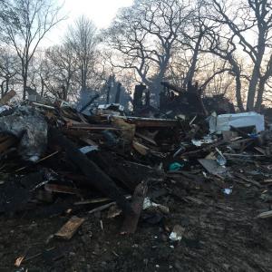 Around sunset May 12, a well-known Newcastle home lies in ruin from a midday fire. SUSAN JOHNS/Wiscasset Newspaper