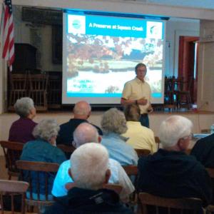 Dennis Dunbar, president of KELT, explains benefits of acquiring the Squam Island Preserve to public hearing attendees. JANE CARPENTER/Boothbay Register