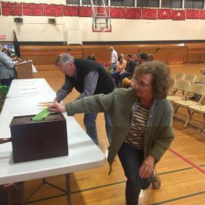 Sandra Shea and husband Dean Shea take part in a written ballot vote at a May 25 Wiscasset town meeting on the school budget.. SUSAN JOHNS/Wiscasset Newspaper