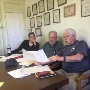 Alna Third Selectman Doug Baston, right, holds documents regarding an area near the Alna town line, as Second Selectman Melissa Spinney and First Selectman David Abbott look on, during the board’s June 15 meeting. SUSAN JOHNS/Wiscasset Newspaper