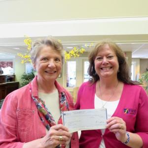 Christine Hopf-Lovette, left, accepts a check for $1,000 from Monique McRae, Wiscasset branch manager of First National Bank, a primary sponsor of LCHA’s Kermess at the Foye-Sortwell Farm. Courtesy photo