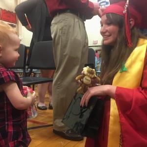 Class of 2016 member Alisyn Richardson, right, meets with cousin Cecily LeRoy, 16 1/2 months, after commencement. SUSAN JOHNS/Wiscasset Newspaper