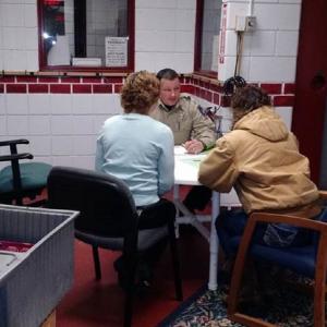 Deputy James Read from LCSO demonstrates a mock intake interview with Bridges to Treatment materials and “comfort kit” -- food, water and blankets for participants. Courtesy photo