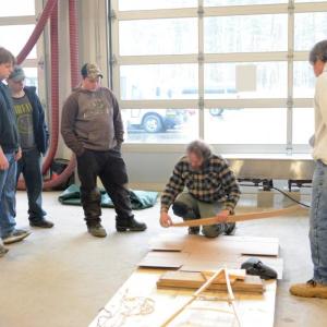 Steve Cayard demonstrates steaming and bending a canoe rib for a class of Lincoln Academy students. Cayard is the master boat builder in charge of the birch bark canoe currently under construction in LA's ATEC center. Courtesy of DRA