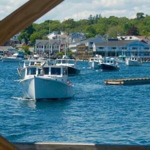A parade of fishing boats approaches the fish pier to be blessed. ART MAYERS/Boothbay Register