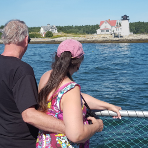A couple observes the Hendricks Head lighthouse on Southport Island aboard the Merrymeeting during a Lighthouse Legends and Lore Cruise last year. Courtesy of Sally Lobkowicz