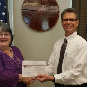 Wiscasset Town Manager Marian Anderson, left, accepts a dividend check from Donald Vickery of Maine Municipal Association’s Risk Management Services. Courtesy of Kathleen Onorato/Town of Wiscasset