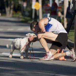 A runner cuddles his dog at last year’s fundraiser. Courtesy photo