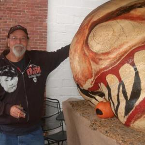 Glenn Chadbourne paints a giant pumpkin. ART MAYERS/Boothbay Register
