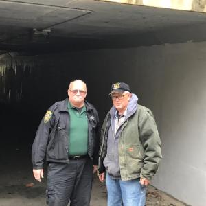 Sagadahoc County Sheriff’s Deputy Carl Fleck and Woolwich Selectmen’s Chair David King stand in front of the newly painted tunnel. Courtesy of Allison Hepler
