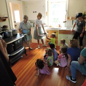 Carol Hillman, as Annie, and Emery Lorrain (Prudy) share stories about life on the island and cookies. Courtesy of Jean McKay