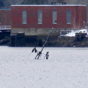 The mast of the 66-foot boat sitting on the bottom of Wiscasset harbor can be seen at low tide. PHIL DI VECE/Wiscasset Newspaper