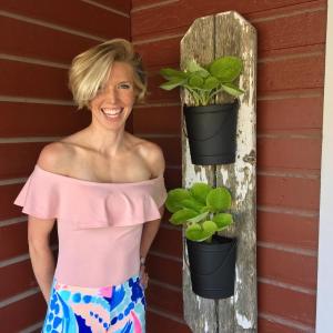 Bailey Bartlett at Montsweag Farms Restaurant, next to one of her pieces of plant art. SUZI THAYER/Boothbay Register