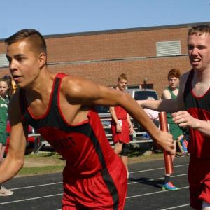 Josh Gabriele takes the hand-off from Nate Gilliam in the first leg of the 4 x 800-meter relay race the Wolverines won at Tuesday’s meet. PHIL DI VECE/Wiscasset Newspaper