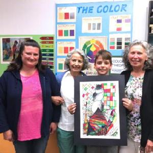 Tucker Davenport holds his drawing, sold at the Maine Art Gallery, with, from left, his mother, Heather, Elaine Pew, and WES art teacher Donna Barnes. Courtesy photo
