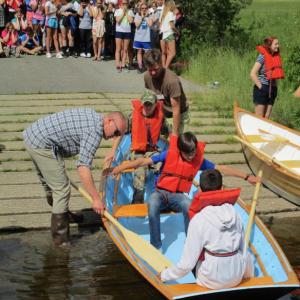 Maine Maritime Museum boatshop manager Kurt Spiridakis, left, and George Sprague lend a hand to Woolwich Central School students at the June 14 boat launch. PHIL DI VECE/Wiscasset Newspaper