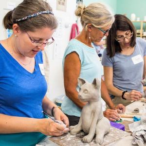 Claudia Olds Goldie, right, assists workshop participants with their projects earlier this month. Courtesy of Claire Brassil