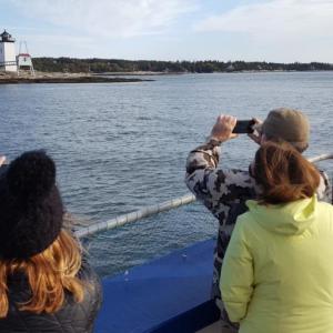 Passengers observe the Hendricks Head lighthouse on Southport Island Maine Maritime Museum’s vessel Merrymeeting during one of the Museum’s Lighthouse Legends and Lore Cruises with Red Cloak Tours. Courtesy of Greg Latimer