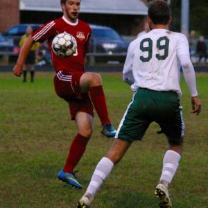 Wolverine James Hodson and Winthrop’s Jared McLaughlin in the opening minutes of Thursday’s game played at Wiscasset Middle High School. PHIL DI VECE/Wiscasset Newspaper