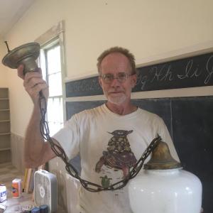 Alna's Chris Cooper shows one of the globe lights that will go back up. SUSAN JOHNS/Wiscasset Newspaper