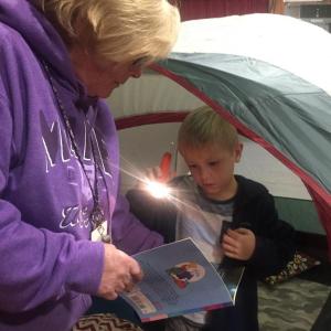 Teacher Mary Bailey and Wiscasset’s Lucas Tarrance, 6, look
at a book together. SUSAN JOHNS/Wiscasset Newspaper