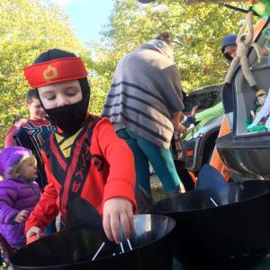 Whyatt Dutton, 4, of Gardiner reaches for treats at Huntoon Hill Grange's Trick or Trunk event Sunday, Oct. 21 in Wiscasset. SUSAN JOHNS/Wiscasset Newspaper