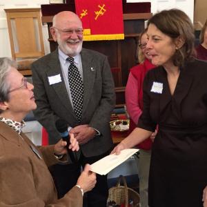 Summerfest co-Chair Nancy Roby hands a donation to MaineHealth Care at Home community liaison Connie Jones as Midcoast Literacy board chair Dave Damour looks on. SUSAN JOHNS/Wiscasset Newspaper