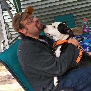 In Woolwich Oct. 7, Brent Scott spends time with Flo, the pitt bull-mix he found soaked and on her own in a North Carolina flood. SUSAN JOHNS/Wiscasset Newspaper
