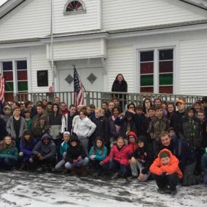 Over a fresh coat of snow Monday morning, Wiscasset Middle High School middle school students bring food donations to the community food bank at the Church of the Nazarene as part of the annual WMHS “Turkey Thyme” Thanksgiving Food Drive. Courtesy of Deb Pooler