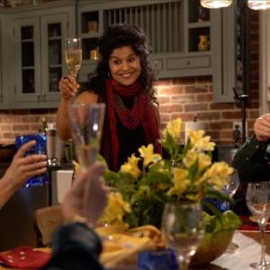 Cherie Scott (standing) leads a toast to the launch of ‘Mumbai to Maine” at the Indian feast at her home. Courtesy of Cherie Scott