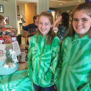 Wiscasset Community Center Unsinkables swim team members Emily Gilliam, left, and Linnea Andersson help man a gift basket fundraiser for the team Dec. 1 in the WCC lobby. SUSAN JOHNS/Wiscasset Newspaper
