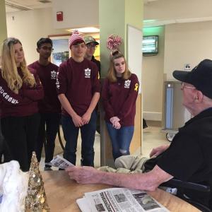 WMHS students, from left, Maddy McLean, Muhammed Khalique, Gage Varian, Archie Brewer and Katelyn Long listen to a veteran speak about his experiences in his military career. Courtesy of Deb Pooler
