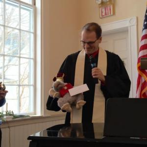 First Congregational Church of Wiscasset Pastor Josh Fitterling holds Charlie the Church Mouse, as one of the magi, during the Jan. 6 service. Looking on with the other magi figures is Libby Mooney. SUSAN JOHNS/Wiscasset Newspaper