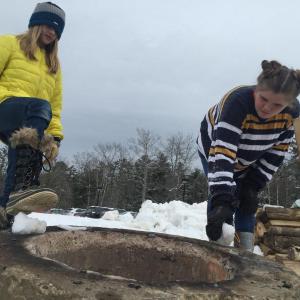 Jessie Willey, left, 10, of Dresden and Linnea Andersson, 12, of Wiscasset visit a bonfire at Winterfest Feb. 2. SUSAN JOHNS/Wiscasset Newspaper