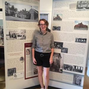 Maine Humanities Council intern Allison Kelley stands in from of two of the six traveling panels about Frances Perkins. Courtesy photo